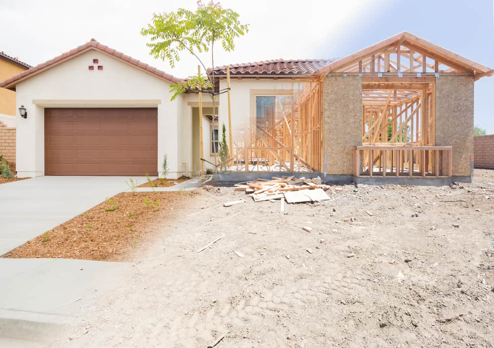 House half finished, showing completed side and exposed framing