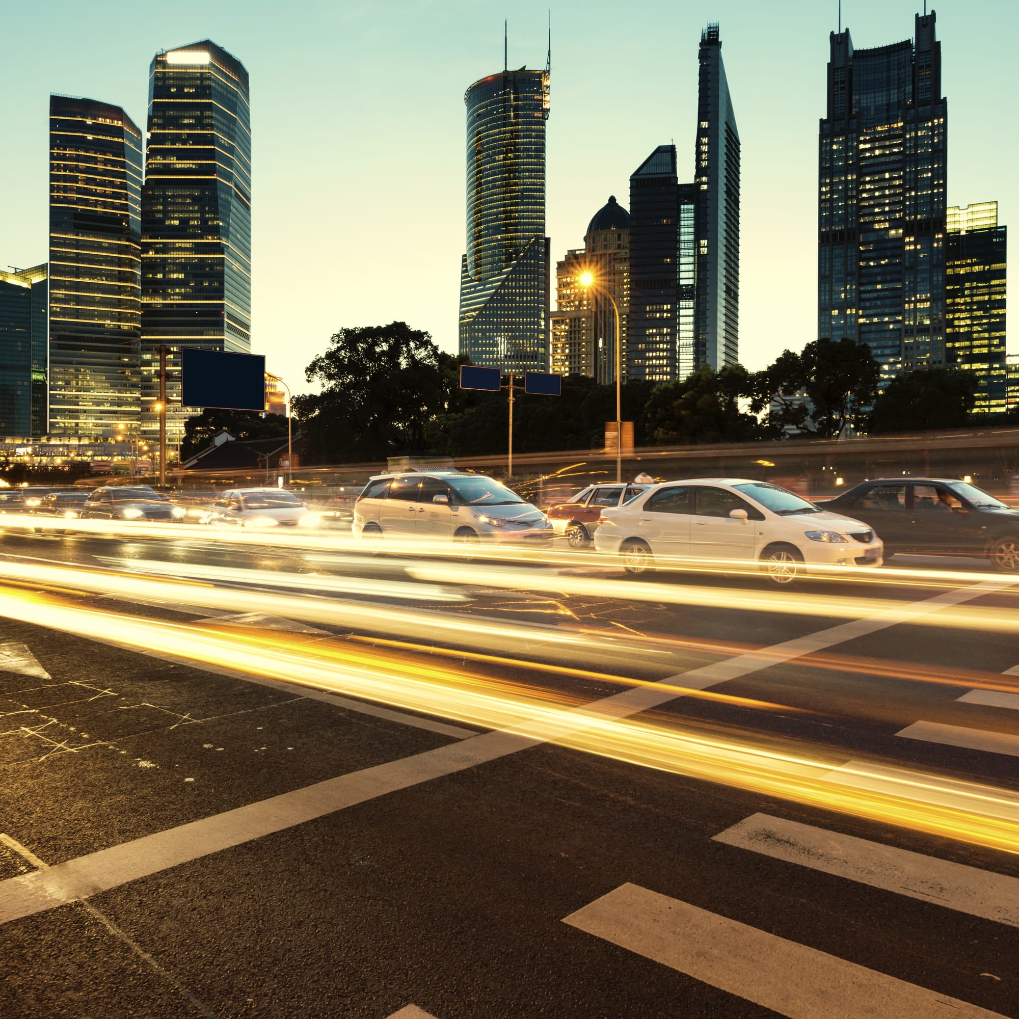 City intersection with light trails at dusk