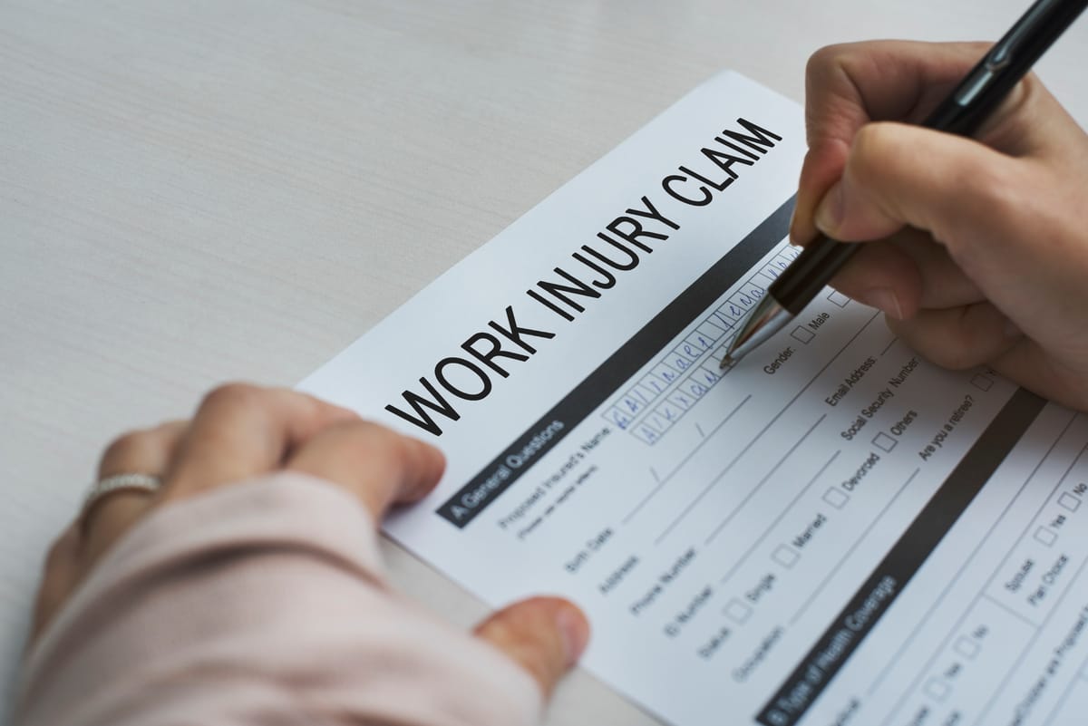 Person filling out work injury claim form