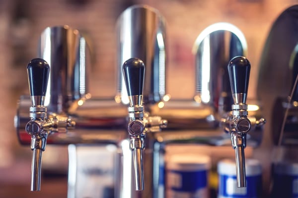 Beer tap system in a high-volume bar, illustrating self-pour beer tap solutions for busy venues