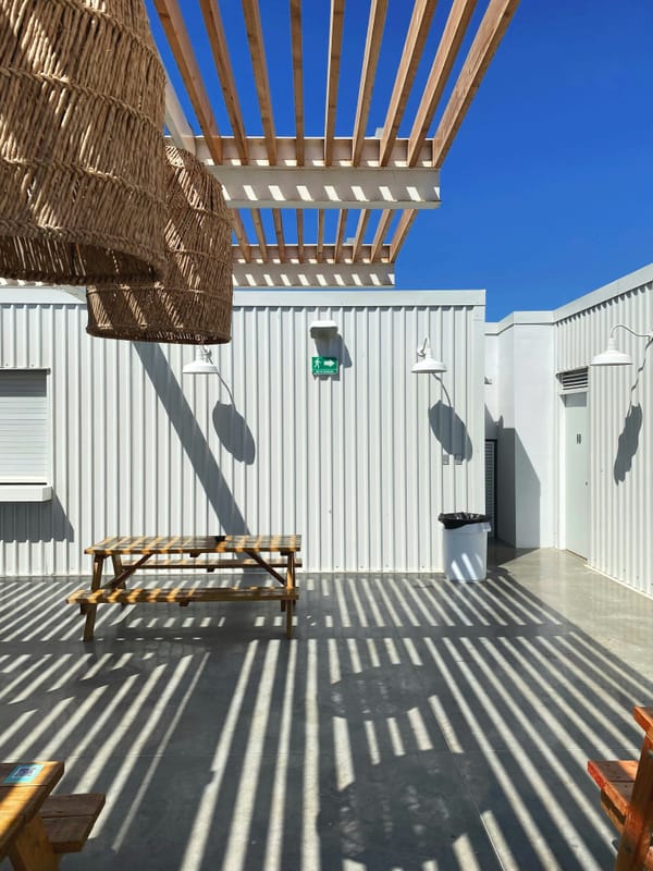 Outdoor patio chairs and tables on a smooth concrete surface