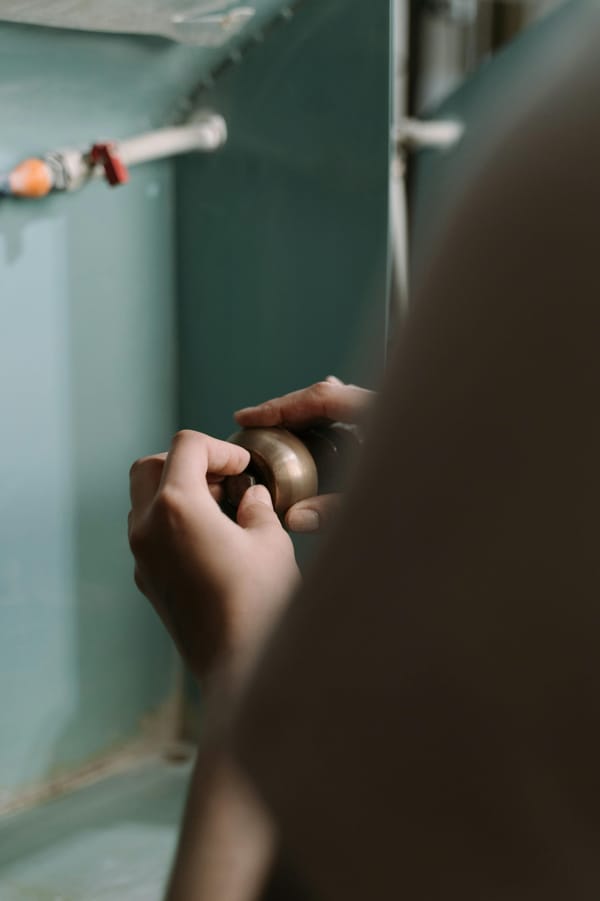 A Person Holding Brown Doorknob