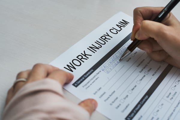 Person filling out work injury claim form